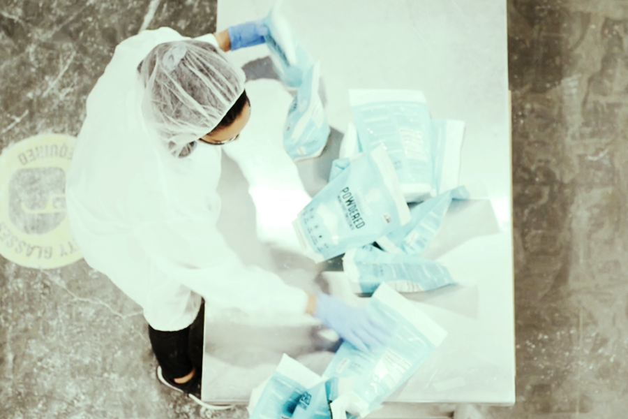 contract manufacturing worker sorting flexible packages