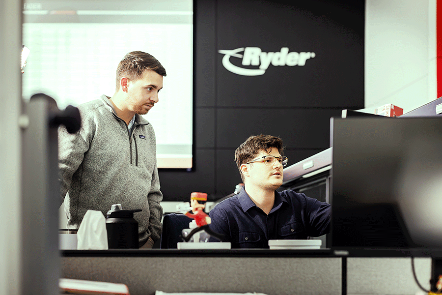 ryder employees reviewing display design on a computer